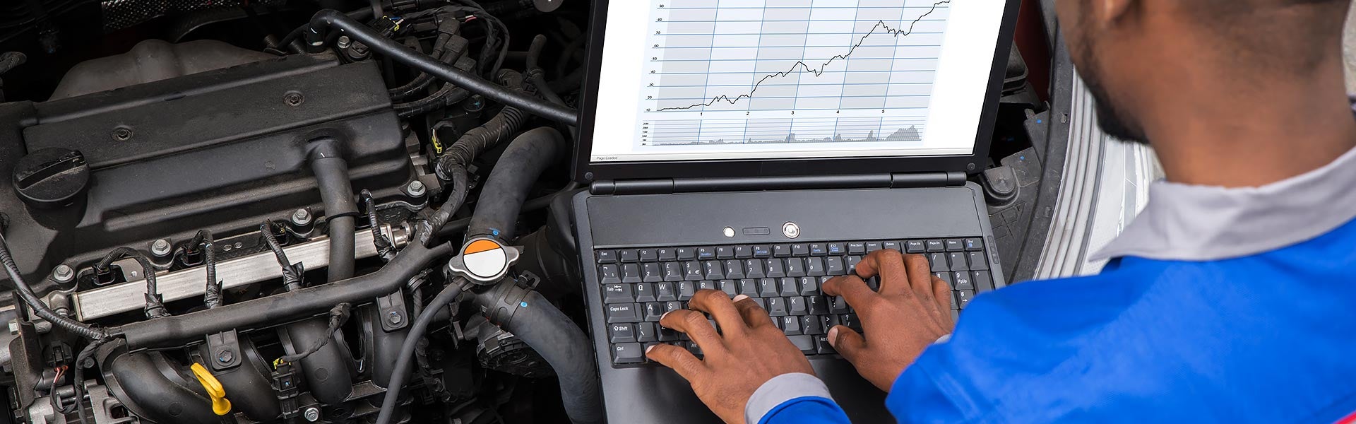 service tech on laptop Miller Auto Body Shop in St. Cloud MN